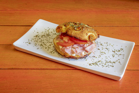 Mixed Italian focaccia with lots of cooked ham, melted cheese, sliced tomato and lots of oreganoの写真素材