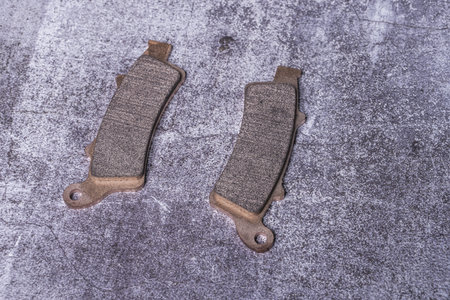Brand new motorcycle brake pads with ferrodo on a gray surfaceの写真素材