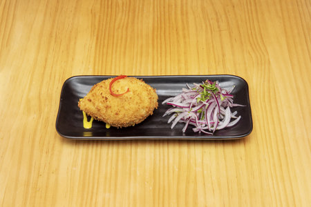 The stuffed potato is a typical frying of several Latin American countries. It consists of a fried cooked potato dough, stuffed with beef, chicken, cheese, onion, olives, hard-boiled eggsの写真素材