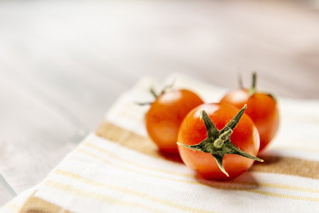 Cherry tomato, its shape can be spherical or slightly oblong. It is usually red, although there are orange, yellow, green and black varietiesの写真素材