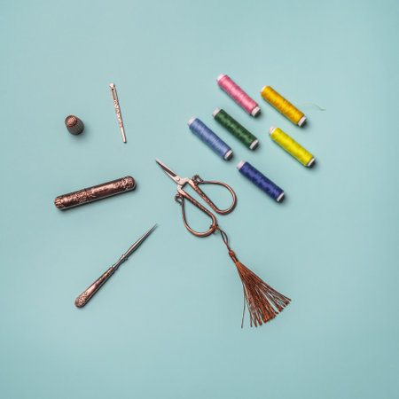 A set for sewing repairs with spools of colored thread and copper vintage style scissorsの写真素材