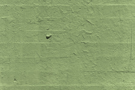 A green painted brick wall with chips and lumps. vector paint texture backgroundの写真素材