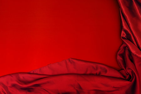 A blood red satin fabric on a smooth red surfaceの写真素材