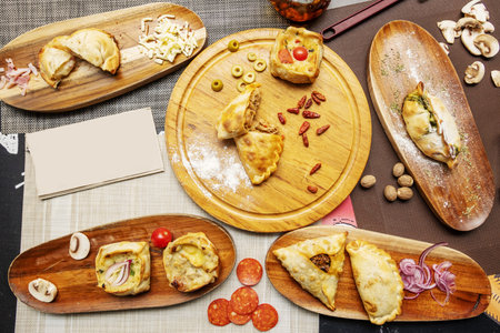 set of dishes with various Argentine empanadas with various fillingsの写真素材