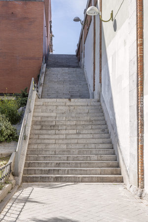 Brown metal fire stairs in an office building with many leafy trees