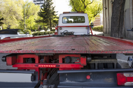 A crane with a red metal platform to load damaged vehiclesの写真素材