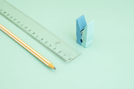 a junot orange graphite pencil with a ruler and a clothespin-shaped eraser