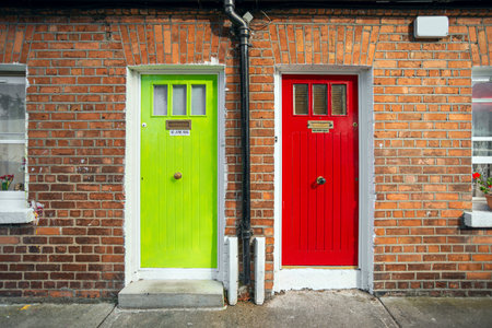 Colorful entrance doors to low-rise brick-fronted homes on the outskirts of Dublin, Ireland