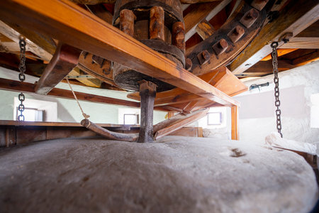 Rudimentary wood and stone machinery grinding wheel of a vintage windmillの写真素材