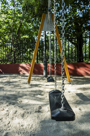 swing seat with chains on a playgroundの写真素材