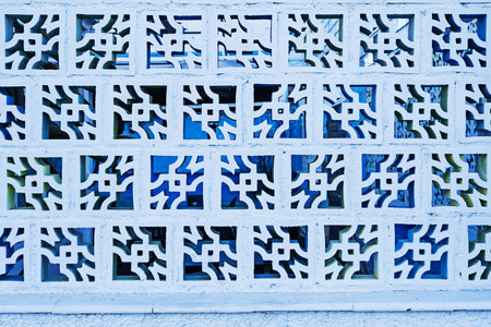 A light blue brick wall with symmetrical patterns