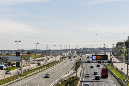 A road with several lanes in various directions towards the city of Madrid, Spainの写真素材