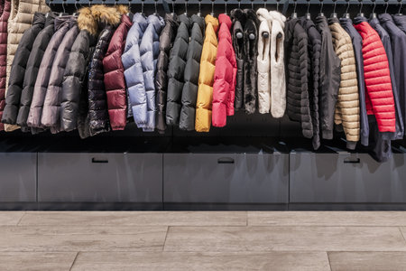 A shelf full of quilted anoraks in a clothing storeの写真素材