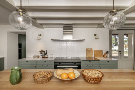 farmhouse style kitchen with white marble countertop, island with wooden countertop and storage...