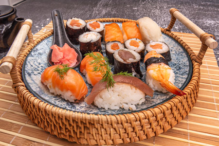 Nigiri is always served with your hands. You don't need to juggle with chopsticks, as they are pieces designed to be picked up with your fingersの写真素材