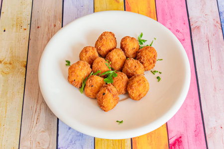 Breaded chicken popcorn on a white porcelain plate