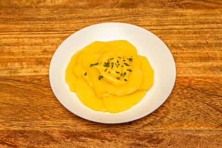 Papa a la huancaÃ­na: Boiled potatoes covered in a creamy sauce made from cheese and yellow chili,...