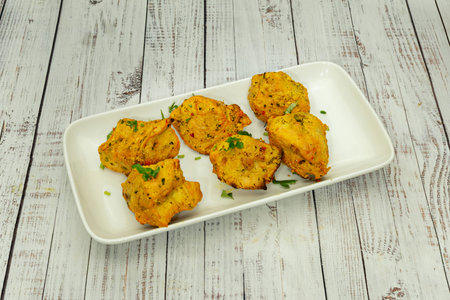 Served on skewers, often accompanied by rice, salad, and sauces.
