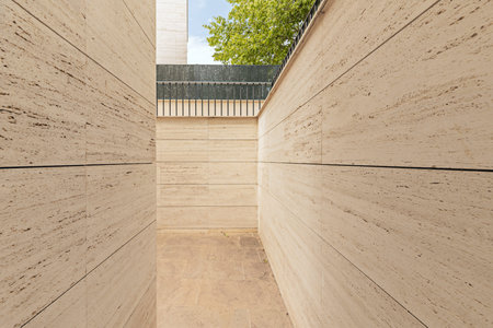 Country residence with rustic marble exterior walls and surrounding cobblestone walkway