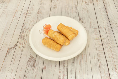 Mini-sized tequeÃ±os perfect for cocktails, showing the same perfect ratio of dough to cheese in a...