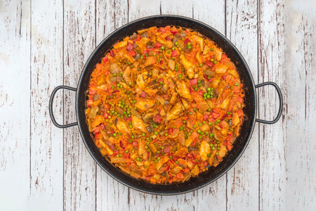 Duck paella with a red wine reduction, showcasing The juicy pieces of meat and the brilliant richの写真素材