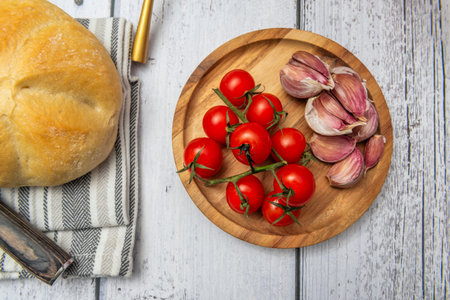 Split cherry tomatoes showing their juicy interior, with oil drops and crispy piecesの写真素材