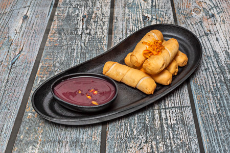 Venezuelan tequeÃ±os served in a wicker basket, highlighting their deep golden color against the...