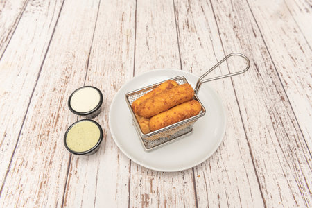Freshly baked Venezuelan tequeÃ±os with their characteristic perfect golden color and crispy wheat...