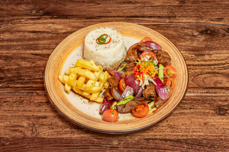A traditional version of lomo saltado with golden fries and rice, a dish that fuses Peruvian and Chinese influences in every biteの写真素材