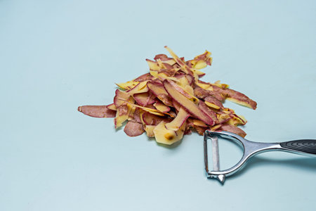 High-end potato peeler gliding smoothly over an uneven surface of homegrown potatoes