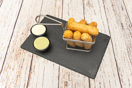 Vintage metal basket filled with freshly baked Venezuelan with their characteristic golden color and...