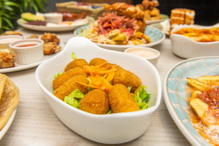 Creamy Serrano ham croquettes with quality bÃ©chamel and golden breadcrumbs, accompanied by freshly sliced ââlemonの写真素材