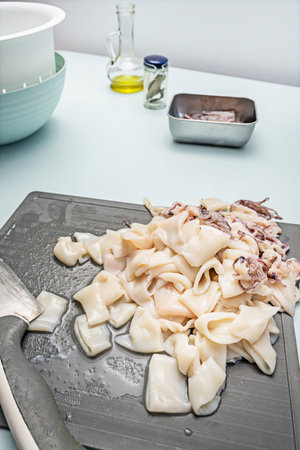 The combination of skinned and unskinned squid pieces creates chromatic variations on the gray...
