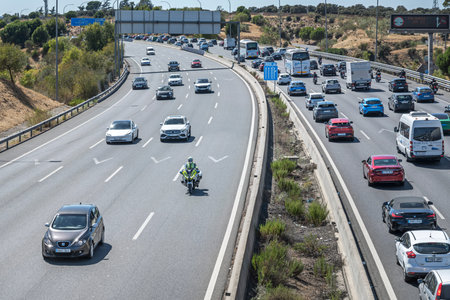 Urban expressway with lanes packed with modern and vintage cars mixed together in slow motion