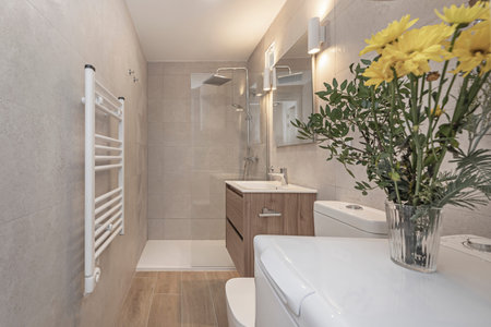 Designer shower with a shower panel Natural stone, antique brass faucets, and floating wooden...