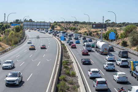 Rural road congested due to a event, with vehicles partially parked on both shoulders
