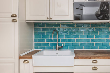 Efficient small kitchen design with a white quartz countertop incorporating a preparation and breakfast area, ideal for modern apartments with limited spaceの写真素材