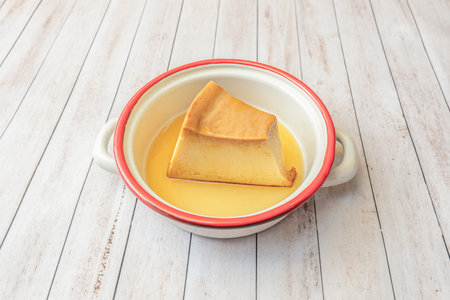 Individual portion of quesillo with an intense vanilla flavor and caramel notes, served on a plate...