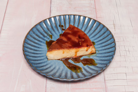 Individual portion of quesillo with an intense vanilla flavor and caramel notes, served on a plate...