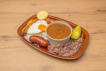 Venezuelan Pabellón Criollo with shredded beef in tomato sauce, fluffy rice, black beans with papelón (unrefined cane sugar), and crispy tostones (fried plantain slices)の写真素材