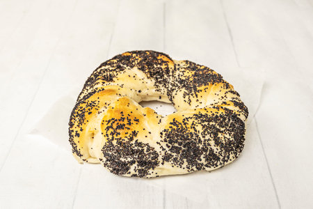 A tempting, vertical stack of freshly baked bagels: savory garlic and onion bagels at the bottom,...
