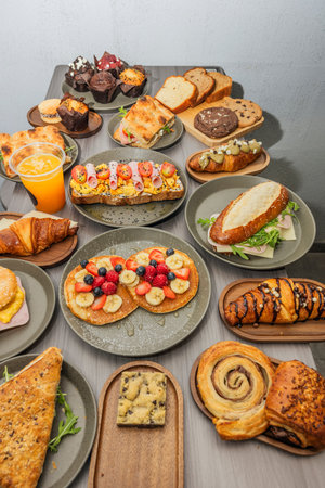 Variety of pastries on a wooden table, top view.