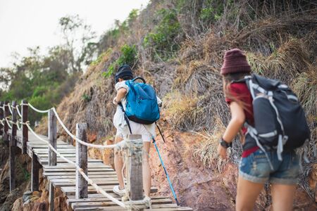 Young women walking hiking in the mountains.の写真素材