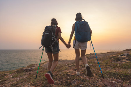 Woman walking with a walking stick in the mountains.