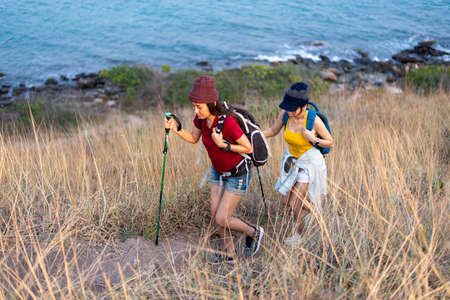 Young women walking hiking in the mountains.の写真素材
