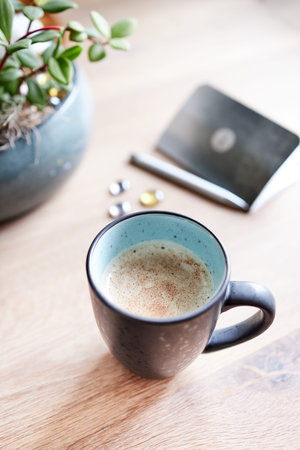 A cup of coffee sitting on top of a wooden table