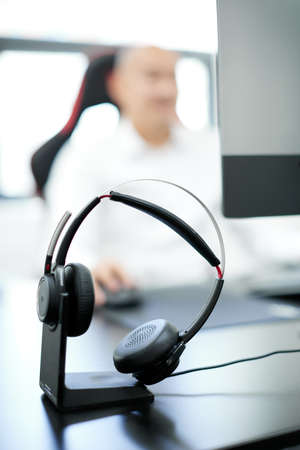 selective focus of call center operators working at workplace with coffee to go in officeの写真素材