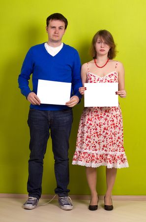 People holding a blank paper. On green background.の写真素材