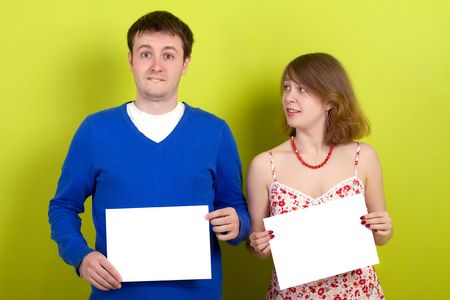 People holding a blank paper. On green background.の写真素材
