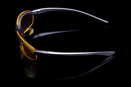Yellow sunglasses Isolated on black.の写真素材